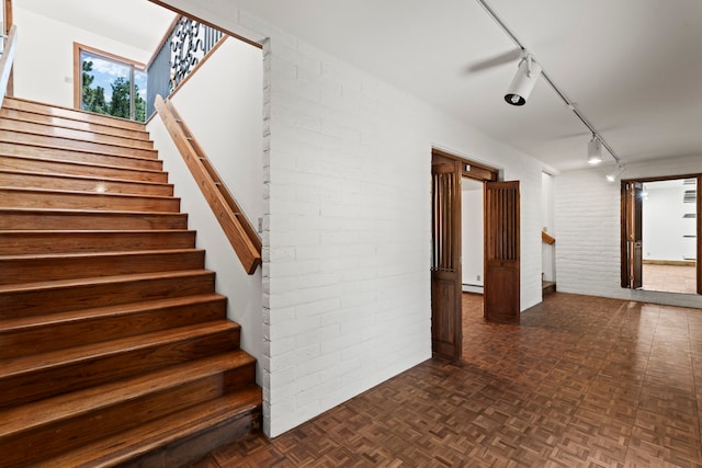 320 Valle Del Sol, White Rock, NM 87547 - stairway featuring brick wall, rail lighting, and a baseboard radiator