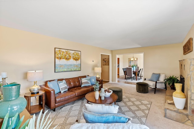 620 Navajo, Los Alamos, NM 87544 - living room featuring carpet flooring, a chandelier, and a fireplace with raised hearth