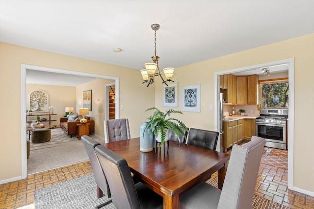620 Navajo, Los Alamos, NM 87544 - dining area with a chandelier and brick patterned flooring