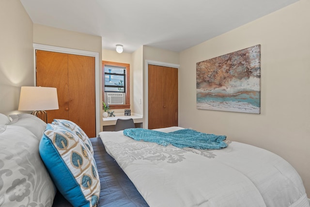 620 Navajo, Los Alamos, NM 87544 - bedroom with multiple closets, cooling unit, and wood finished floors