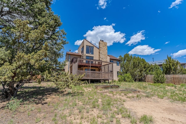 620 Navajo, Los Alamos, NM 87544 - back of house featuring a wooden deck, a chimney, and stucco siding