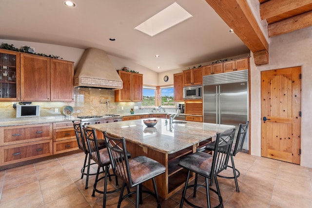 19 Camino Don Carlos, Santa Fe, NM 87506 - kitchen featuring built in appliances, custom exhaust hood, backsplash, brown cabinets, and recessed lighting