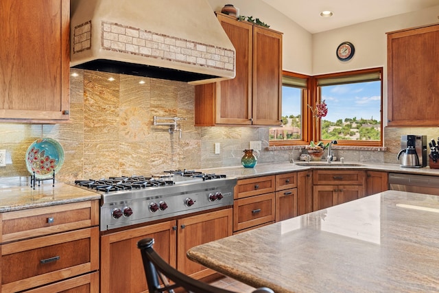 19 Camino Don Carlos, Santa Fe, NM 87506 - kitchen with premium range hood, appliances with stainless steel finishes, backsplash, light stone counters, and brown cabinetry