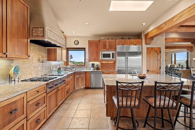 19 Camino Don Carlos, Santa Fe, NM 87506 - kitchen featuring built in appliances, backsplash, healthy amount of natural light, light stone counters, and recessed lighting