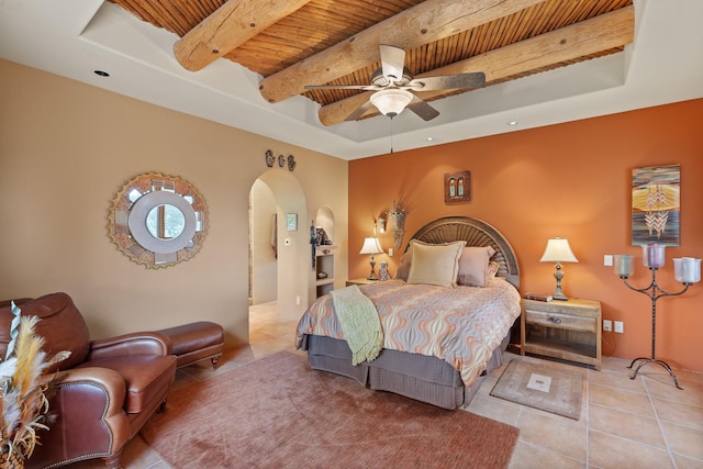 19 Camino Don Carlos, Santa Fe, NM 87506 - bedroom with a wooden ceiling with exposed beams, tile patterned flooring, arched walkways, a raised ceiling, and a ceiling fan