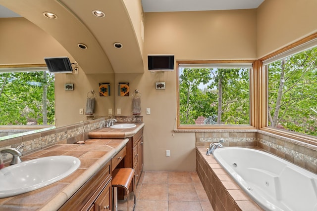 19 Camino Don Carlos, Santa Fe, NM 87506 - full bath with double vanity, healthy amount of natural light, a whirlpool tub, recessed lighting, and backsplash