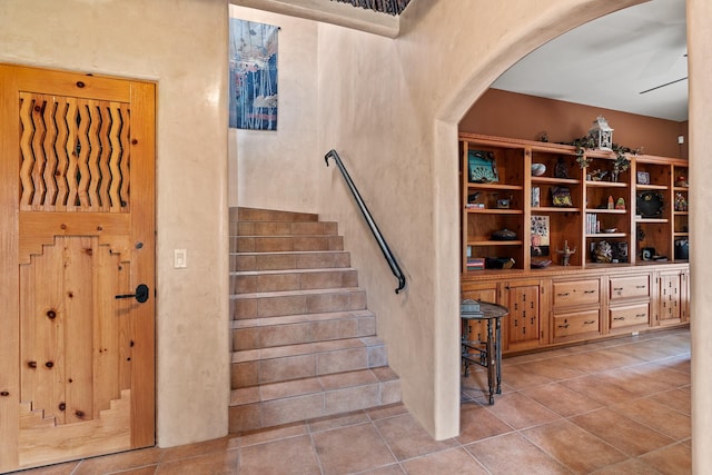19 Camino Don Carlos, Santa Fe, NM 87506 - stairway featuring arched walkways, tile patterned floors, and ceiling fan