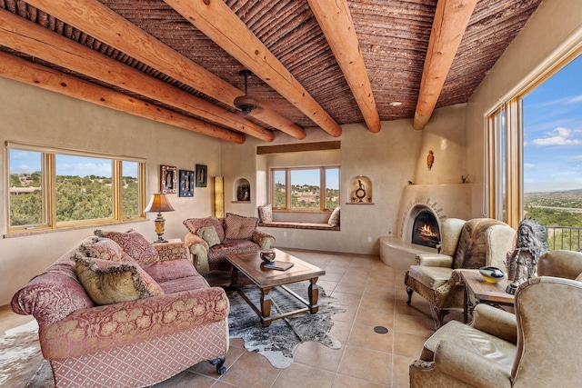 19 Camino Don Carlos, Santa Fe, NM 87506 - living room with a wooden ceiling with exposed beams, tile patterned flooring, and a warm lit fireplace