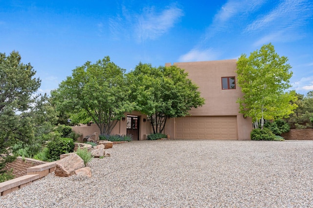 19 Camino Don Carlos, Santa Fe, NM 87506 - adobe home with stucco siding, a garage, and driveway