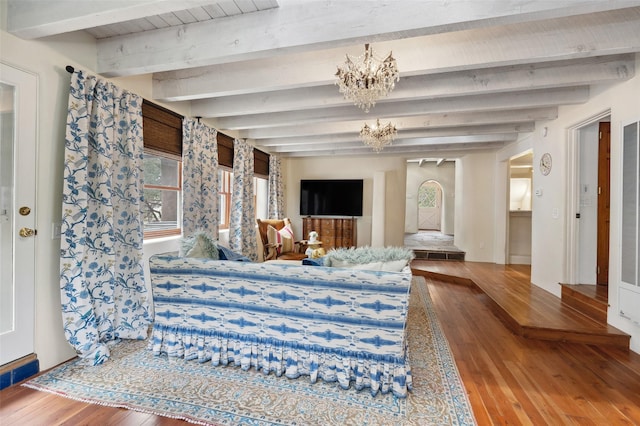 46 Sibley, Santa Fe, NM 87508 - bedroom featuring beam ceiling, hardwood / wood-style floors, and a chandelier