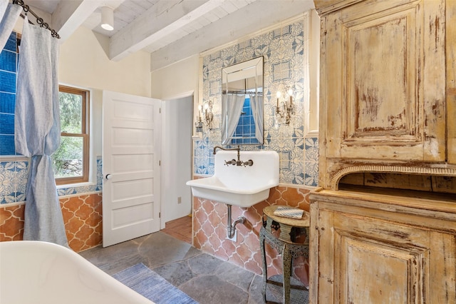 46 Sibley, Santa Fe, NM 87508 - full bathroom featuring a freestanding tub, a wooden ceiling with exposed beams, and stone flooring