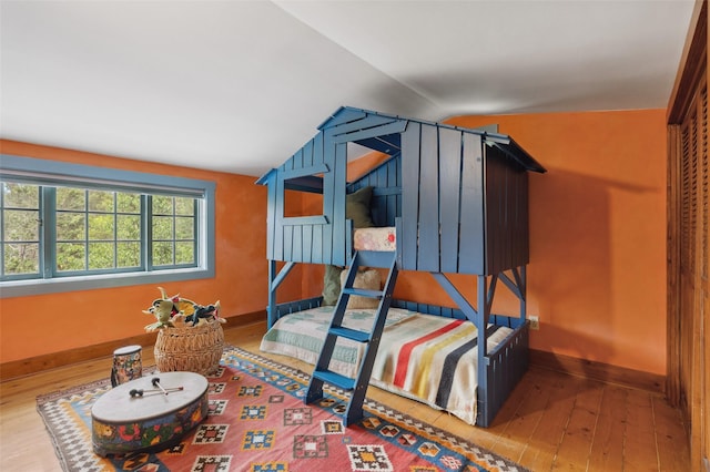 46 Sibley, Santa Fe, NM 87508 - bedroom with wood-type flooring and lofted ceiling