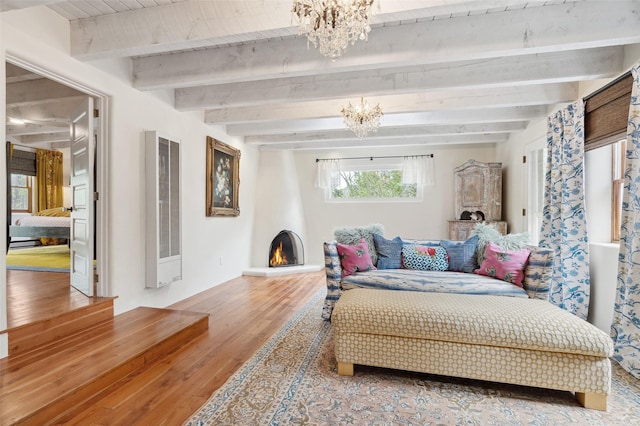 46 Sibley, Santa Fe, NM 87508 - living room featuring a chandelier, wood-type flooring, a large fireplace, beamed ceiling, and a heating unit