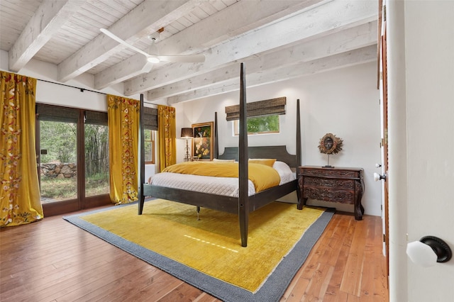 46 Sibley, Santa Fe, NM 87508 - bedroom featuring light wood-type flooring, multiple windows, a wood ceiling with exposed beams, and access to exterior