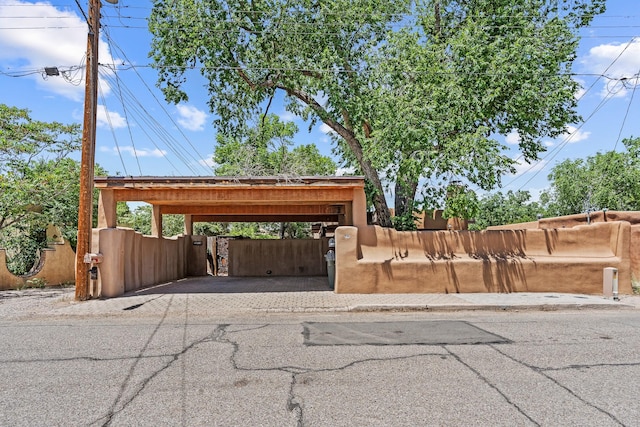 234 Ambrosio Unit A, Santa Fe, NM 87501 - view of car parking with a fenced front yard, a gate, asphalt driveway, and a carport