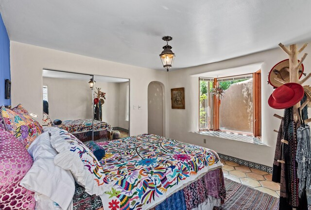 234 Ambrosio Unit A, Santa Fe, NM 87501 - tiled bedroom featuring arched walkways