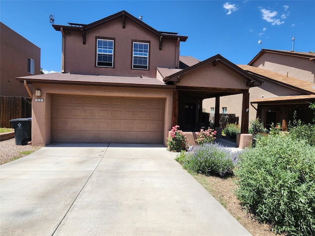310 Grand Cyn, White Rock, NM 87547 - view of front of house with a garage, stucco siding, and driveway