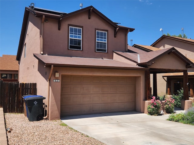 310 Grand Cyn, White Rock, NM 87547 - view of front of house with driveway, stucco siding, and a garage