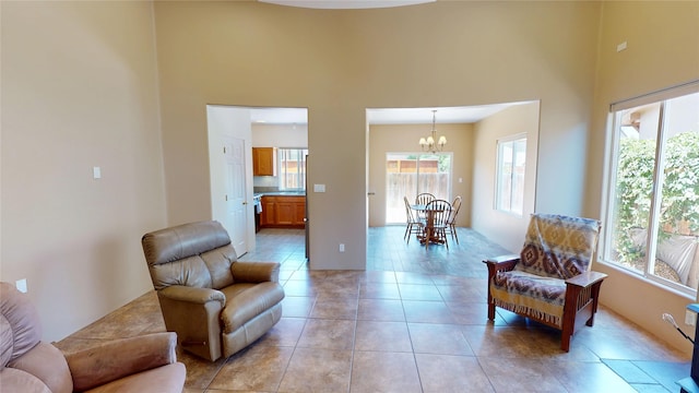 310 Grand Cyn, White Rock, NM 87547 - living area with a chandelier, a high ceiling, healthy amount of natural light, and light tile patterned floors