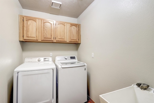 10 Carlito Rd, Santa Fe, NM 87508 - washroom featuring independent washer and dryer, cabinet space, and a textured ceiling