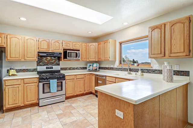 10 Carlito Rd, Santa Fe, NM 87508 - kitchen with appliances with stainless steel finishes, a skylight, light brown cabinets, decorative backsplash, and recessed lighting