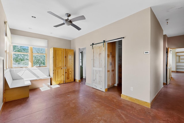 37 Camino Tetzcoco, Santa Fe, NM 87508 - unfurnished bedroom with concrete flooring and a barn door