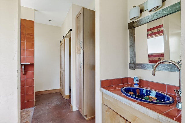 37 Camino Tetzcoco, Santa Fe, NM 87508 - bathroom with concrete floors and vanity