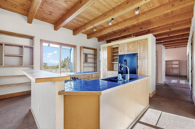 37 Camino Tetzcoco, Santa Fe, NM 87508 - kitchen featuring black refrigerator with ice dispenser, rail lighting, tile countertops, open shelves, and a kitchen island with sink