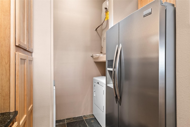 1405 Vegas Verdes Unit 136, Santa Fe, NM 87507 - kitchen with stainless steel refrigerator with ice dispenser, separate washer and dryer, and dark stone finish floors