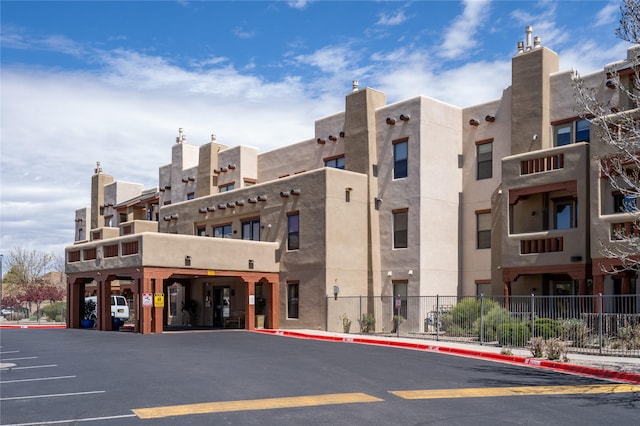 1405 Vegas Verdes Unit 136, Santa Fe, NM 87507 - view of building exterior featuring uncovered parking