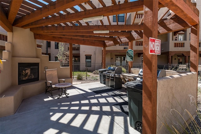 1405 Vegas Verdes Unit 136, Santa Fe, NM 87507 - view of patio with a fireplace, grilling area, and a pergola