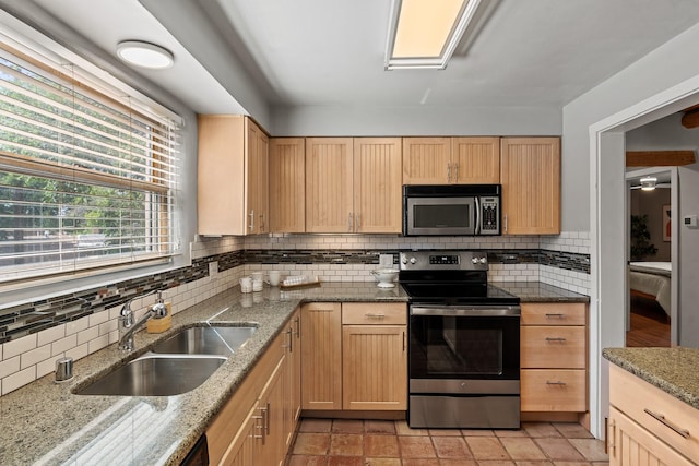 610 Rio Grande Ave, Santa Fe, NM 87501 - kitchen with appliances with stainless steel finishes, tasteful backsplash, light brown cabinetry, and light stone counters
