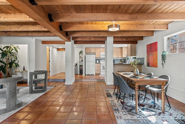 610 Rio Grande Ave, Santa Fe, NM 87501 - dining room with a wood ceiling with exposed beams, tile patterned flooring, and a wood stove