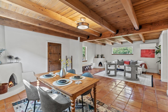 610 Rio Grande Ave, Santa Fe, NM 87501 - dining room with a wall mounted AC, a wood ceiling with exposed beams, a lit fireplace, and tile patterned floors