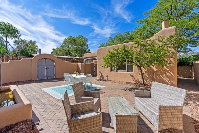 610 Rio Grande Ave, Santa Fe, NM 87501 - view of patio featuring a gate and outdoor dining space