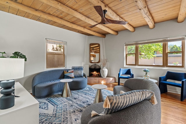 610 Rio Grande Ave, Santa Fe, NM 87501 - living room with a wood ceiling with exposed beams, light wood-type flooring, a tiled fireplace, and ceiling fan