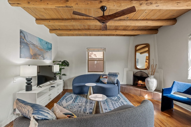 610 Rio Grande Ave, Santa Fe, NM 87501 - living room featuring a wooden ceiling with exposed beams, wood finished floors, and a tiled fireplace
