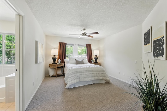4857 Yucca St, Los Alamos, NM 87544 - bedroom featuring a textured ceiling, connected bathroom, ceiling fan, and light colored carpet