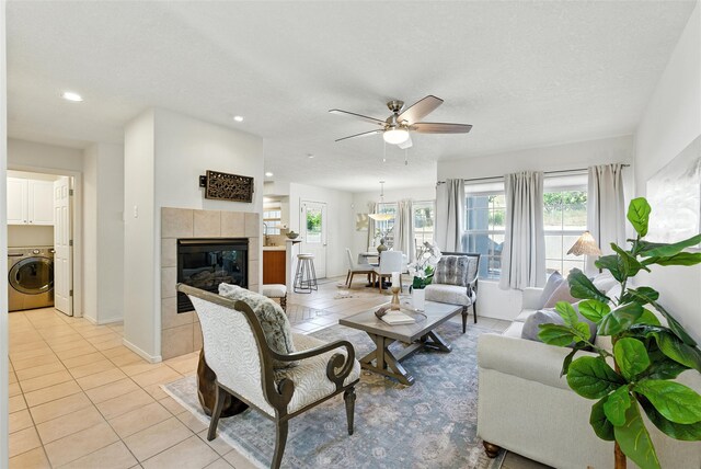 4857 Yucca St, Los Alamos, NM 87544 - living room featuring washer / clothes dryer, light tile patterned flooring, a ceiling fan, recessed lighting, and a tiled fireplace
