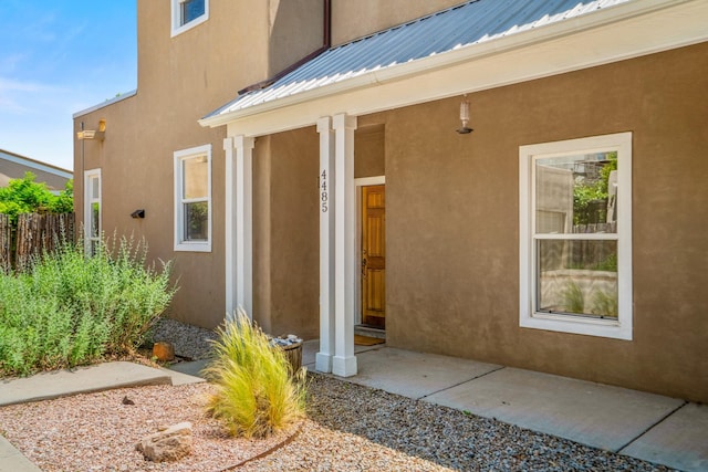 4485 Dancing Ground Rd, Santa Fe, NM 87507 - view of exterior entry featuring a metal roof and stucco siding