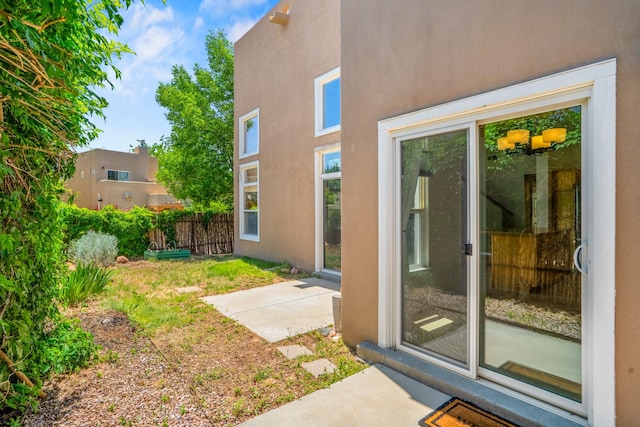 4485 Dancing Ground Rd, Santa Fe, NM 87507 - doorway to property with stucco siding