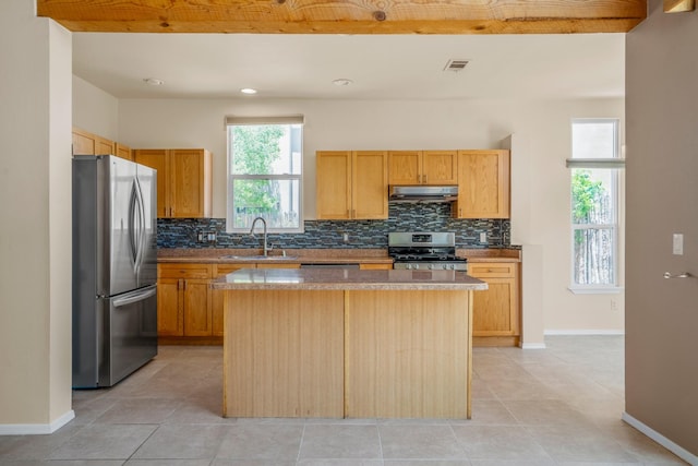 4485 Dancing Ground Rd, Santa Fe, NM 87507 - kitchen featuring stainless steel appliances, under cabinet range hood, decorative backsplash, and a kitchen island