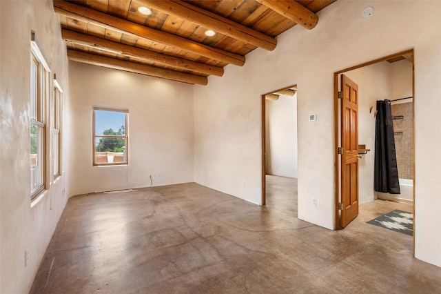 815 Baca Unit C, Santa Fe, NM 87505 - unfurnished room with a wooden ceiling with exposed beams, concrete flooring, and a smoke detector