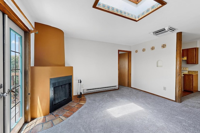 2600 Zia Unit C6, Santa Fe, NM 87505 - unfurnished living room featuring a baseboard radiator, a fireplace with flush hearth, a skylight, and carpet