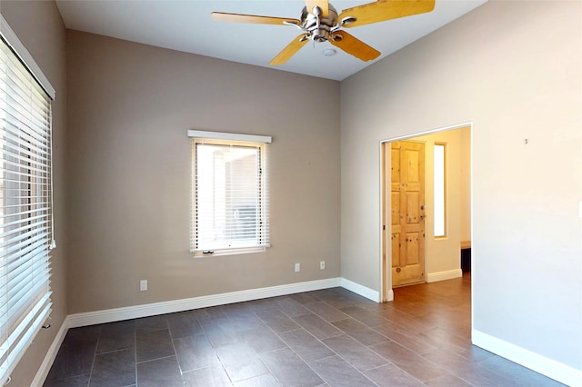 5045 Carriage House Dr, Los Alamos, NM 87544 - empty room featuring a ceiling fan and dark tile patterned floors