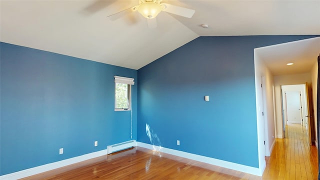 5045 Carriage House Dr, Los Alamos, NM 87544 - spare room featuring a baseboard heating unit, a ceiling fan, vaulted ceiling, light wood-type flooring, and a smoke detector