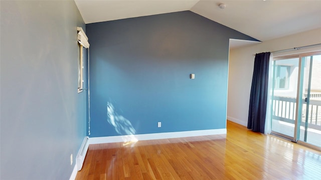 5045 Carriage House Dr, Los Alamos, NM 87544 - empty room with vaulted ceiling, a baseboard radiator, light wood finished floors, and a smoke detector
