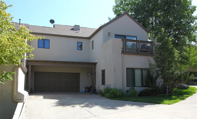 5045 Carriage House Dr, Los Alamos, NM 87544 - view of front facade featuring a balcony, stucco siding, a garage, and driveway