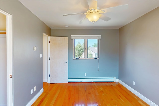 5045 Carriage House Dr, Los Alamos, NM 87544 - unfurnished bedroom with baseboard heating, wood finished floors, and ceiling fan