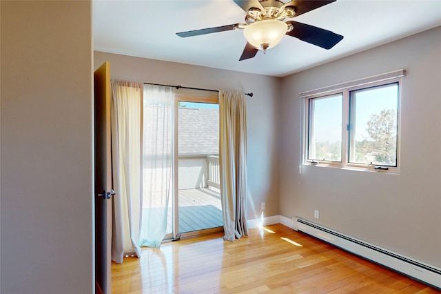5045 Carriage House Dr, Los Alamos, NM 87544 - spare room featuring a baseboard radiator, light wood-type flooring, and a ceiling fan